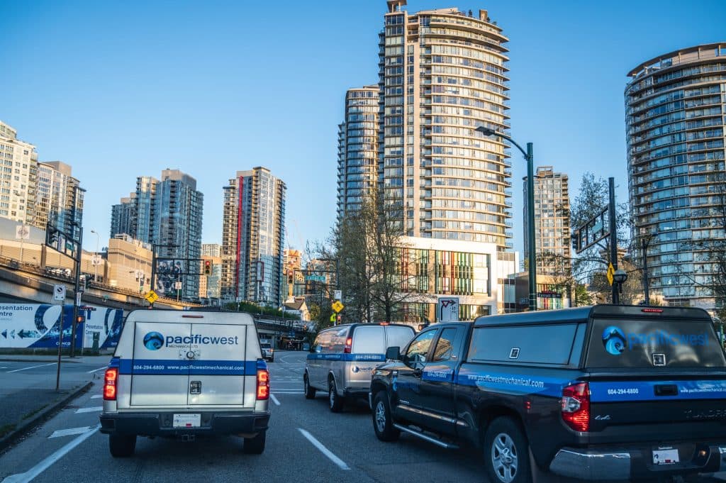 Pacific West Mechanical trucks on a downtown Vancouver street