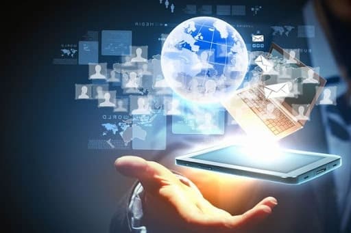 A tablet held in an open hand, with building data floating above it