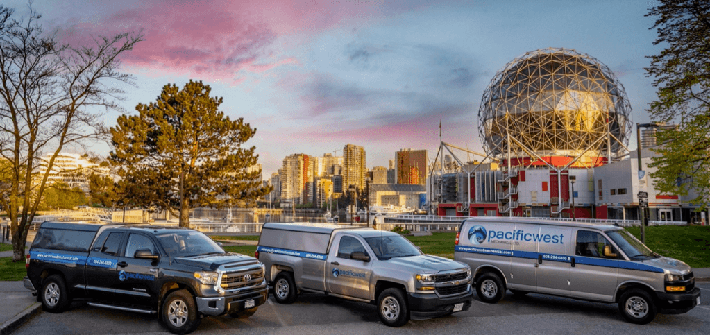 Pacific West Mechanical trucks in front of Science World at sunset
